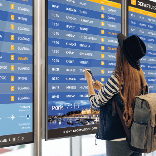 Passenger in an airport using digital signage to find information